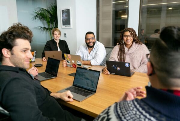 Group of employees working around a table